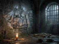 Celda de piedra con un barco de vela dibujado en la pared que brilla a la luz de una vela